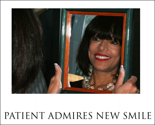 A woman admires her beautiful Teeth In A Day smile at Pi Dental Center