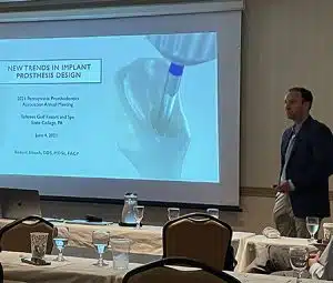 Dr. Slauch lecturing about dental implant prosthesis design