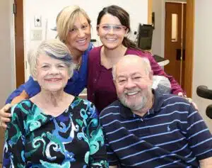 Burnace with his wife and Pi Dental Center clinical staff